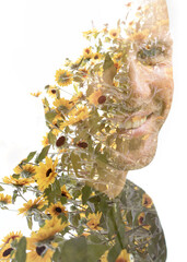A double exposure portrait of a smiling man combined with a photo of flowers - 739351048