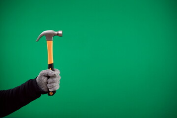 man's hand holding a hammer on a plain background