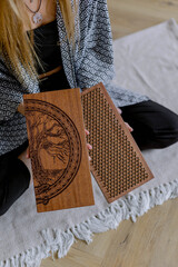 Sadhu board for meditation in female hands. Holiday gift. A tool for rest and relaxation.