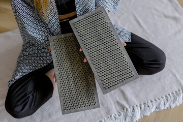 Women's hands hold a meditation board. Rest and relaxation with yoga.