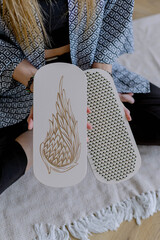 Sadhu board for meditation in female hands. Holiday gift. A tool for rest and relaxation.