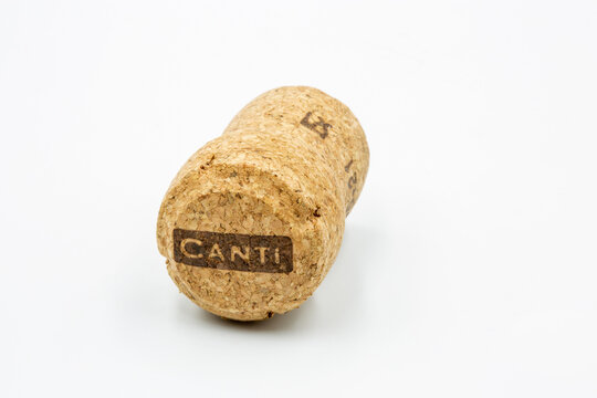 Cork from bottle of Italian sparkling wine closeup against white.