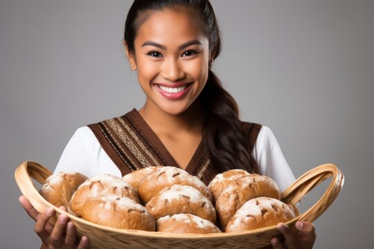 Smiling woman holding a basket of bread
