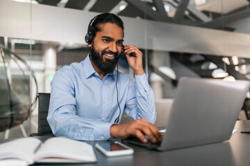 Indian Customer Support Manager Man In Headset Working With Laptop