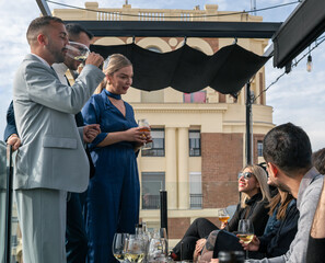 Group of friends together celebrating a special event dressed in elegant clothes.