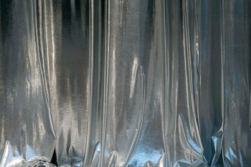 Silver fashionable curtains, fabric in the theatre, night club as texture or background
