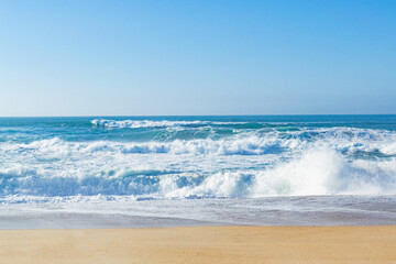 Beautiful ocean waves on a golden sand beach. Alone with nature.