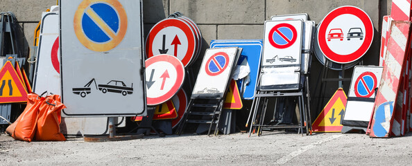 warehouse of the many road signs used by the construction company also with the no parking road sign - Powered by Adobe