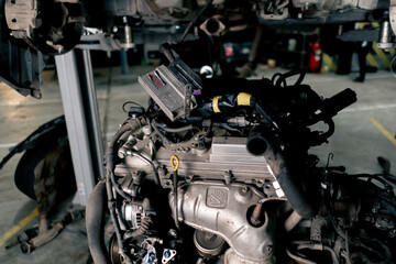 close up There is an elongated engine on the service station table ready for car