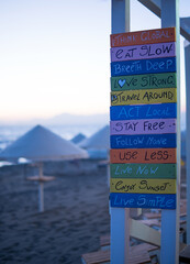 wooden sign on the beach, motivational.