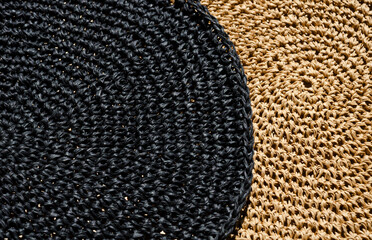 Raffia napkins, black and beige, close-up. Eco material for handmade work.