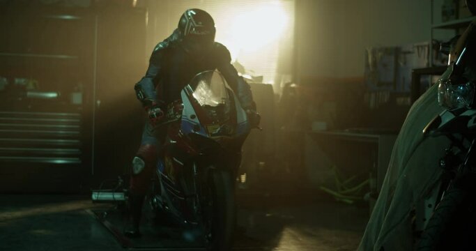 Male motorcyclist riding motorbike in garage