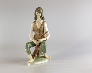 Figurine of a young man with a guitar. Porcelain figurine made in the GDR.