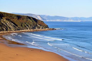 Barinatxe beach on the coast of Bizkaia. In the background, the Port of Bilbao wind farm. Basque Country. Spain