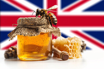 Bee and golden honey jar with the flag of the United Kingdom in the background. Generative AI image.	