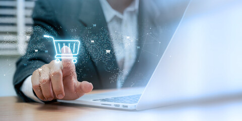 E-commerce or online shopping concept. businessman uses a laptop to browse an online shopping basket, using global technology and the internet to purchase and sell services over the network.