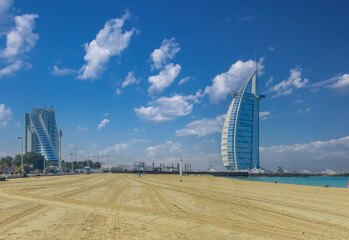 Landscape view of famous Dubai jumeirah beach and sea in summer, famous building and fishing boats background. UAE..​