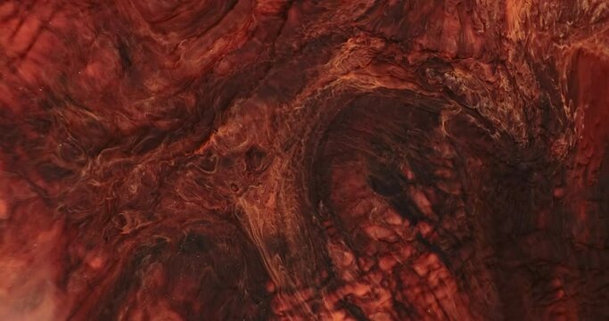 Abstract copper red paint dynamic flowing background. Dark orange color ink mixing with brown shade in colorful art texture. Vivid bronze marble movement. Acrylic chemical splash moving in water. 4k
