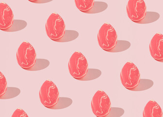 Sponges for applying make-up on the face in the shape of an egg, creative Easter pattern on a pastel pink background.