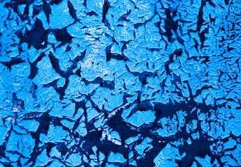 Cracked blue paint on the wall