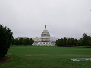 View of the back of the United States Capitol, Washington DC, with a large green grass. One of the...