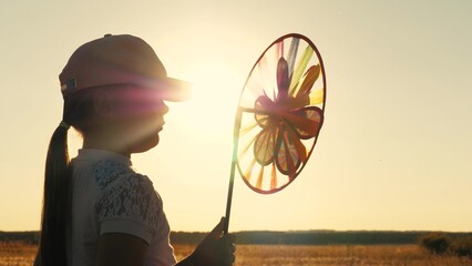 toy windmill sunset, child girl looking sunset holding windmill hand, catching wind glare sunset, glare sunset toy windmill, child silhouette with windmill her hand, child girl daughter dream, family
