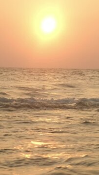 Vertical video. Scenic seascape. Beautiful ocean waves at sunset.