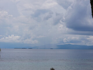 Rain on the mainland seen from an island in the Caribbean Sea, San Blas Archipelago, Panama