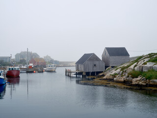 The calm waters of Nova Scotia's Peggy's cove Harbor are a safe haven for the local lobster fishing...