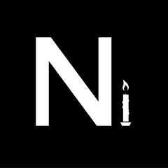 The letter N with a candle on a black background, in tribute to memory and sorrow of a famous political figure