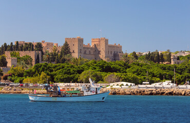 A picturesque view of the city embankment and the fort of Rhodes on a sunny day.