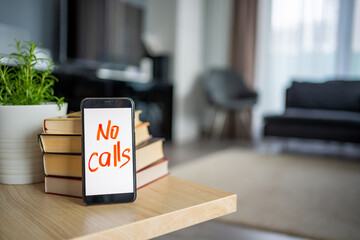 Digital detox concept. In the foreground is a smartphone with the text No Calls