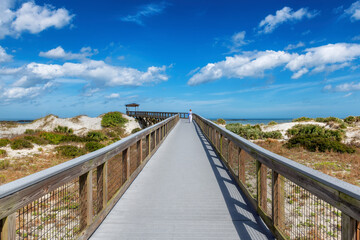 Fototapeta na wymiar Smyrna Dunes Park with elevated boardwalk and fishing pier in New Smyrna Beach, Florida.