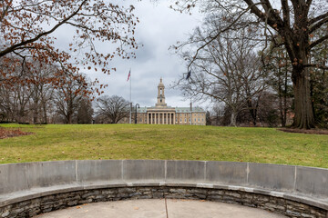 The Old Main building on the campus of Penn State University in spring cloudy day, State College,...