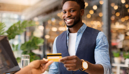 Businessman happily paying for a shop purchase with a credit card - obrazy, fototapety, plakaty