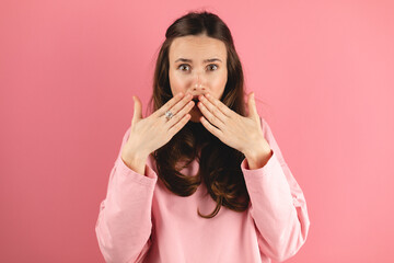 Shocked woman wearing casual pink long sleeves top opens mouth advert unbelievable big shopping...
