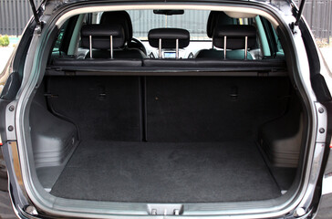 Rear view of a SUV car with open trunk. Ready for luggage loading.
