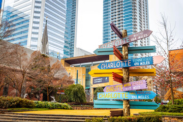 Colorful directions signs in Charlotte The Green city center park