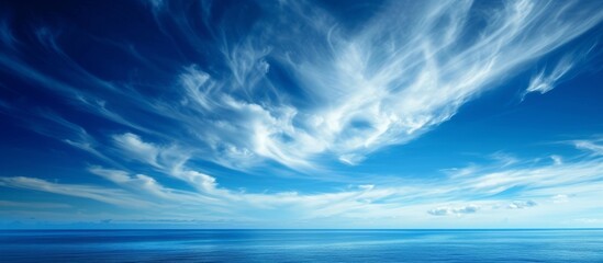 Fototapeta na wymiar Serene Beauty of a Stunning Blue Sky with Fluffy Clouds Over the Vast Ocean