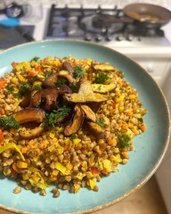 plate with buckwheat, buckwheat with finely chopped vegetables, fried shitake mushrooms, healthy cereals