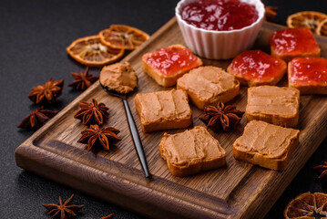 Fototapeta na wymiar Delicious nutritious sandwiches with peanut butter, strawberry jam