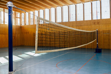 A volleyball net at indoor court with no people.