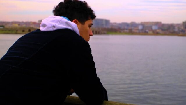 Depressed Teenager on the Bridge and Cloudy Sky