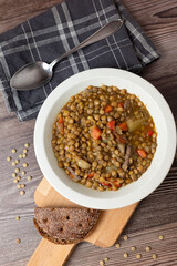 Homemade spicy lentil soup on dark wooden bacground