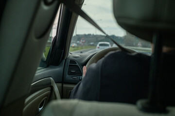 The Man Sitting in the Driver's Seat and the Road