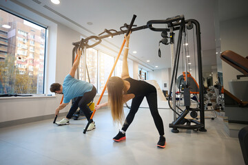 Female and male perform stretching exercises