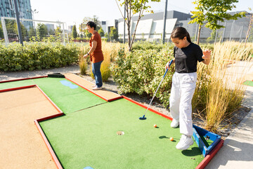 Kids playing golf inside playground artificial grass activity game for children 