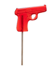 Red lollipop pistol on wooden stick isolated on white