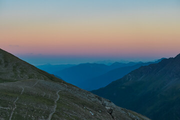 Panoramic sunset view of majestic mountain peaks in High Tauern National Park, Salzburg Carinthia border, Austria. Tranquil atmosphere in remote Austrian Alps. Looking from cottage Hagener Huette