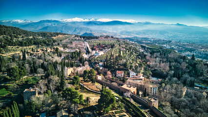 Drone shot of the Alhambra in Granada with the snowy mountains in the background